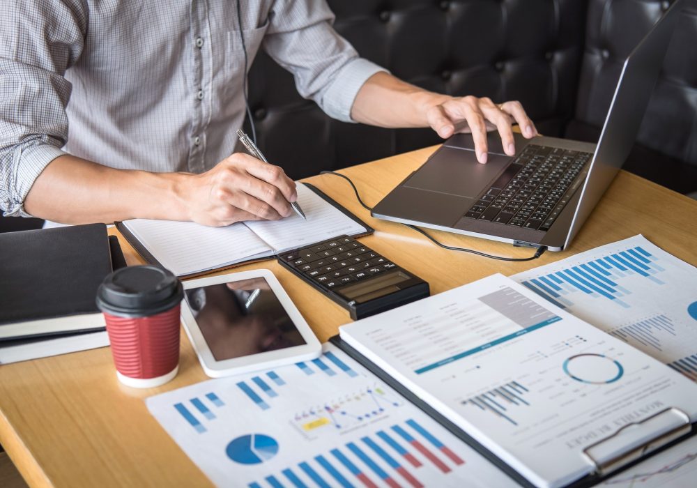 businessman accountant working audit and calculating expense financial annual financial report